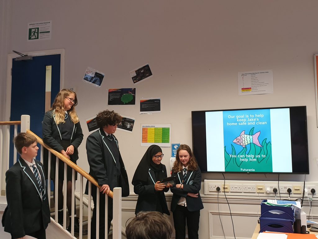 Students presenting in front of TV board