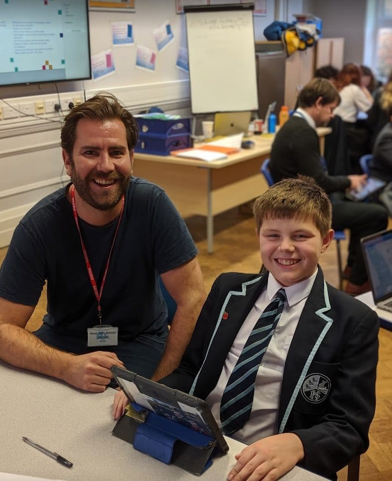 Tom Chute smiling with student